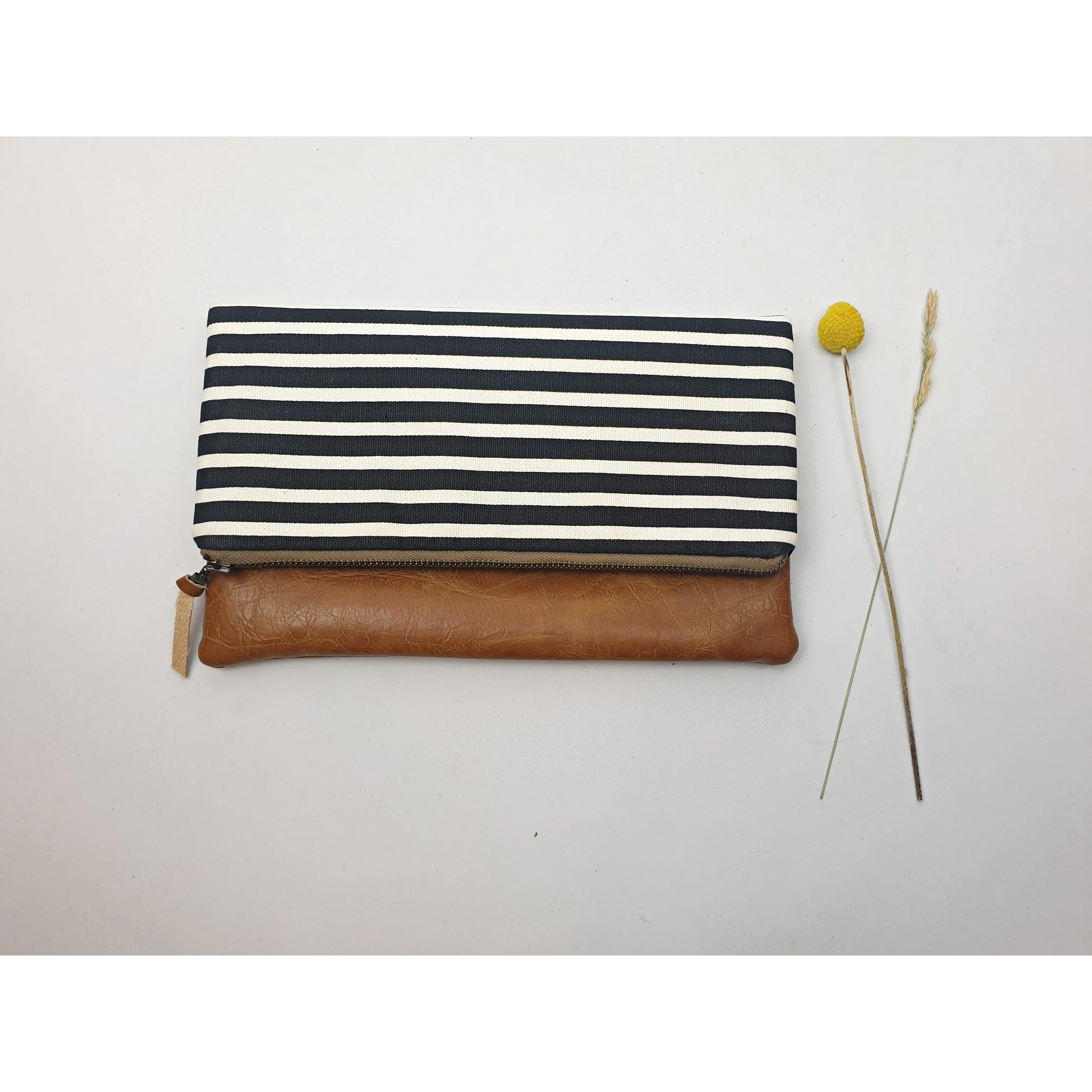 Maddie Kay brown faux leather foldover clutch with navy and white striped fabric