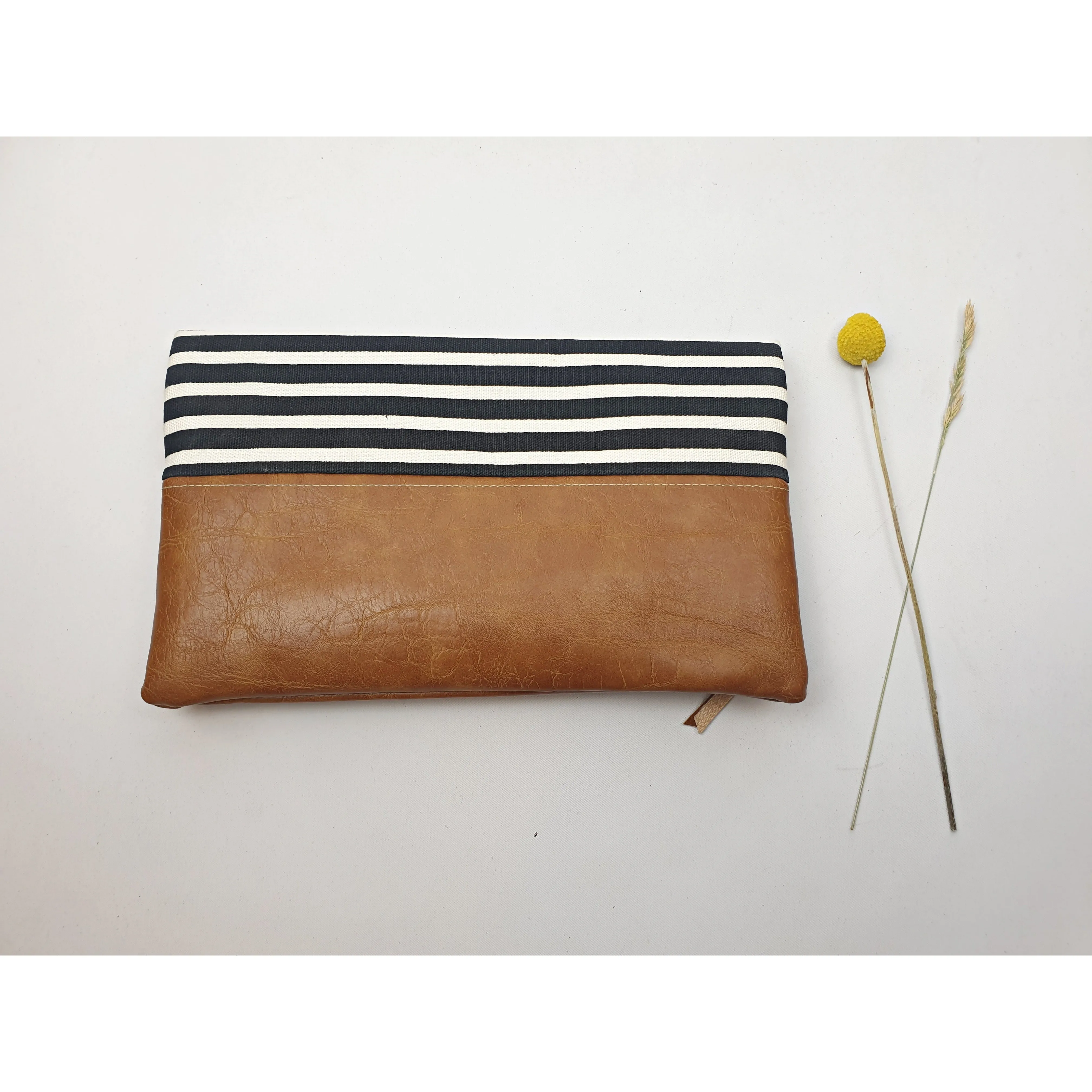 Maddie Kay brown faux leather foldover clutch with navy and white striped fabric