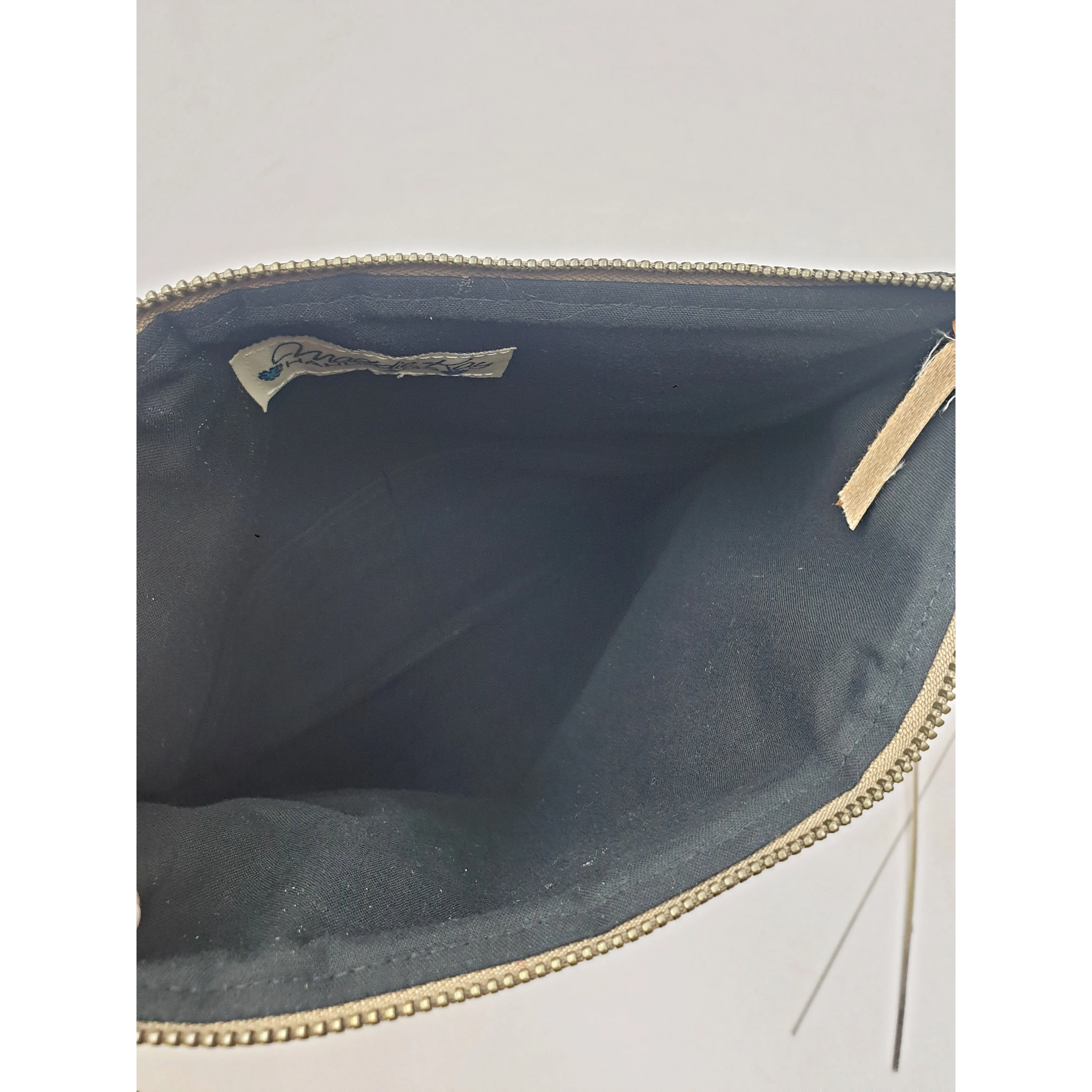 Maddie Kay brown faux leather foldover clutch with navy and white striped fabric