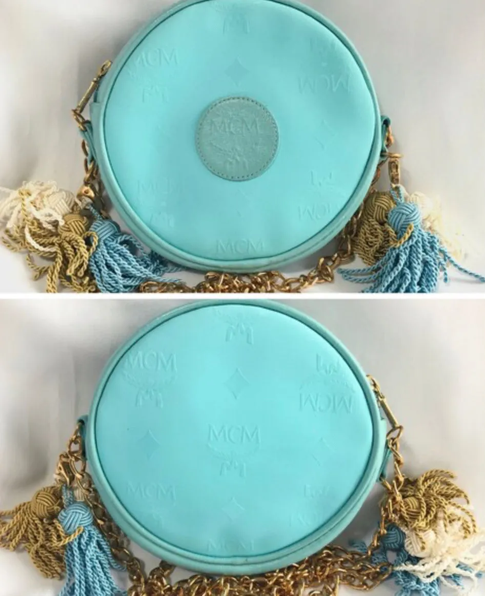 MINT. Vintage MCM blue monogram mini Suzy Wong pouch bag with golden chain and blue, gold, and white fringes. Michael Cromer. 0404041