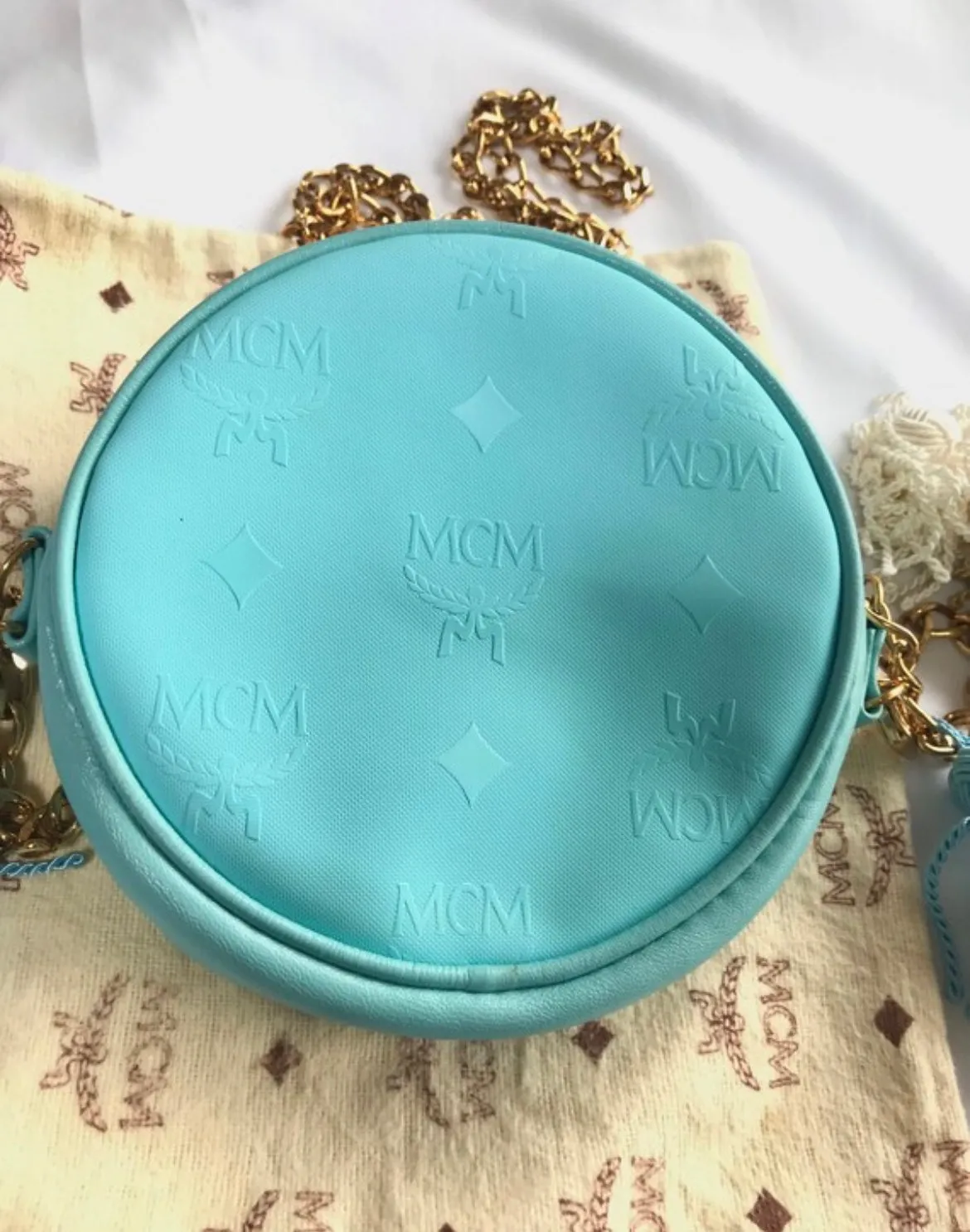 MINT. Vintage MCM blue monogram mini Suzy Wong pouch bag with golden chain and blue, gold, and white fringes. Michael Cromer. 0404041